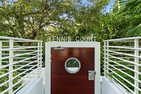 a view of a door of a house with a backyard