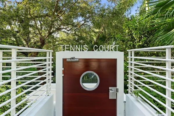 a view of a door of a house with a backyard
