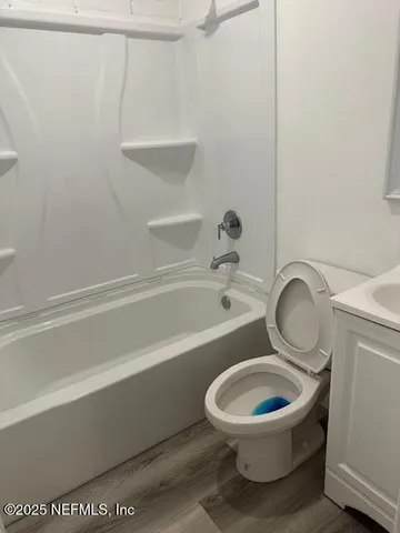 a bathroom with a toilet and a bathtub