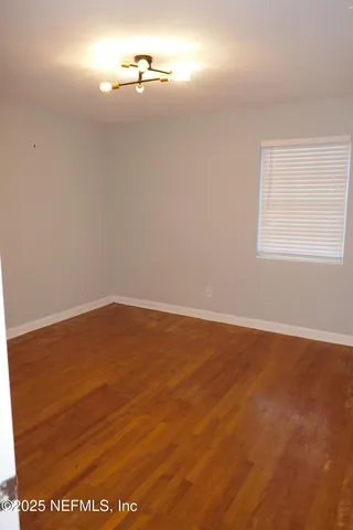 an empty room with wooden floor