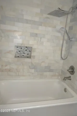 a bathroom with a shower and a bathtub