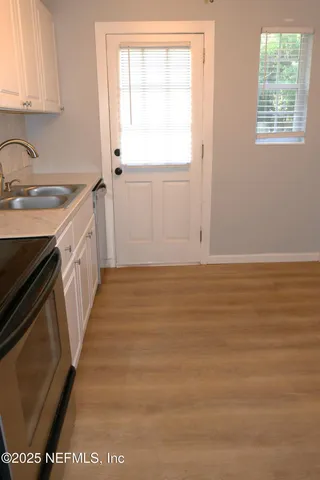 a bathroom with a sink a window and a mirror