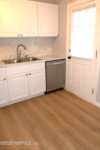 a kitchen with a sink and cabinets