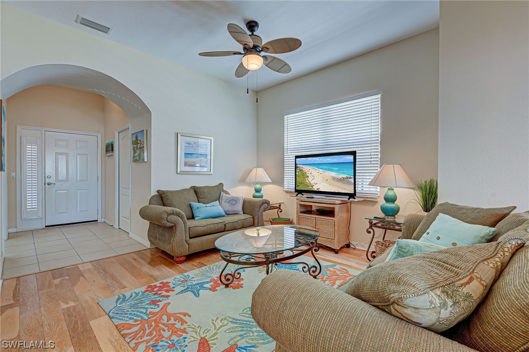 604 Ravinia Circle, Unit 604 Venice, FL 34292 - Photo 11 of 37 a living room with furniture a rug and a ceiling fan