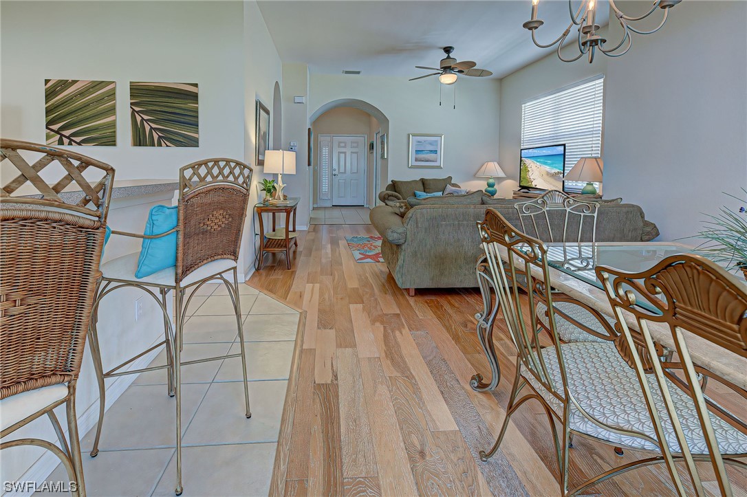 604 Ravinia Circle, Unit 604 Venice, FL 34292 - Photo 14 of 37 a living room with furniture a fireplace and wooden floor