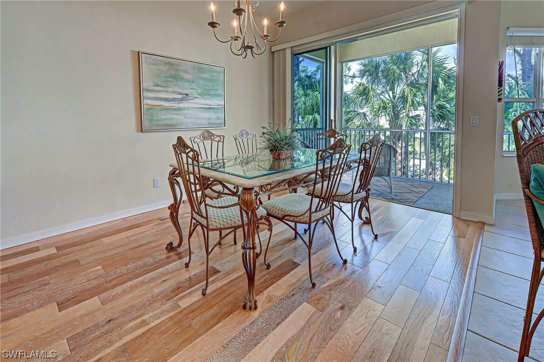 604 Ravinia Circle, Unit 604 Venice, FL 34292 - Photo 16 of 37 a dining room with furniture window wooden floor