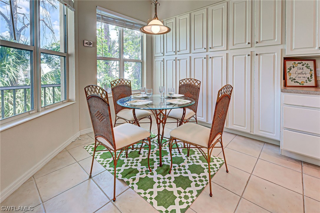 604 Ravinia Circle, Unit 604 Venice, FL 34292 - Photo 17 of 37 a view of a dining room with furniture wooden floor and a chandelier