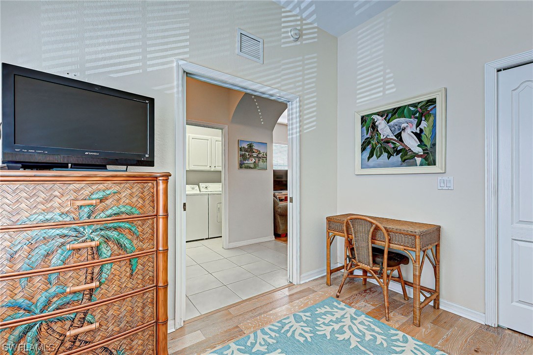 604 Ravinia Circle, Unit 604 Venice, FL 34292 - Photo 23 of 37 a room with furniture and a flat screen tv