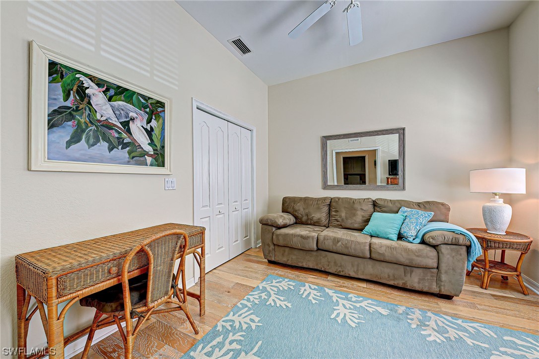 604 Ravinia Circle, Unit 604 Venice, FL 34292 - Photo 24 of 37 a living room with furniture and a wooden floor