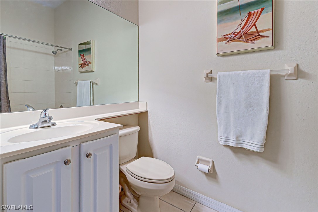 604 Ravinia Circle, Unit 604 Venice, FL 34292 - Photo 34 of 37 a bathroom with a granite countertop sink mirror vanity and toilet