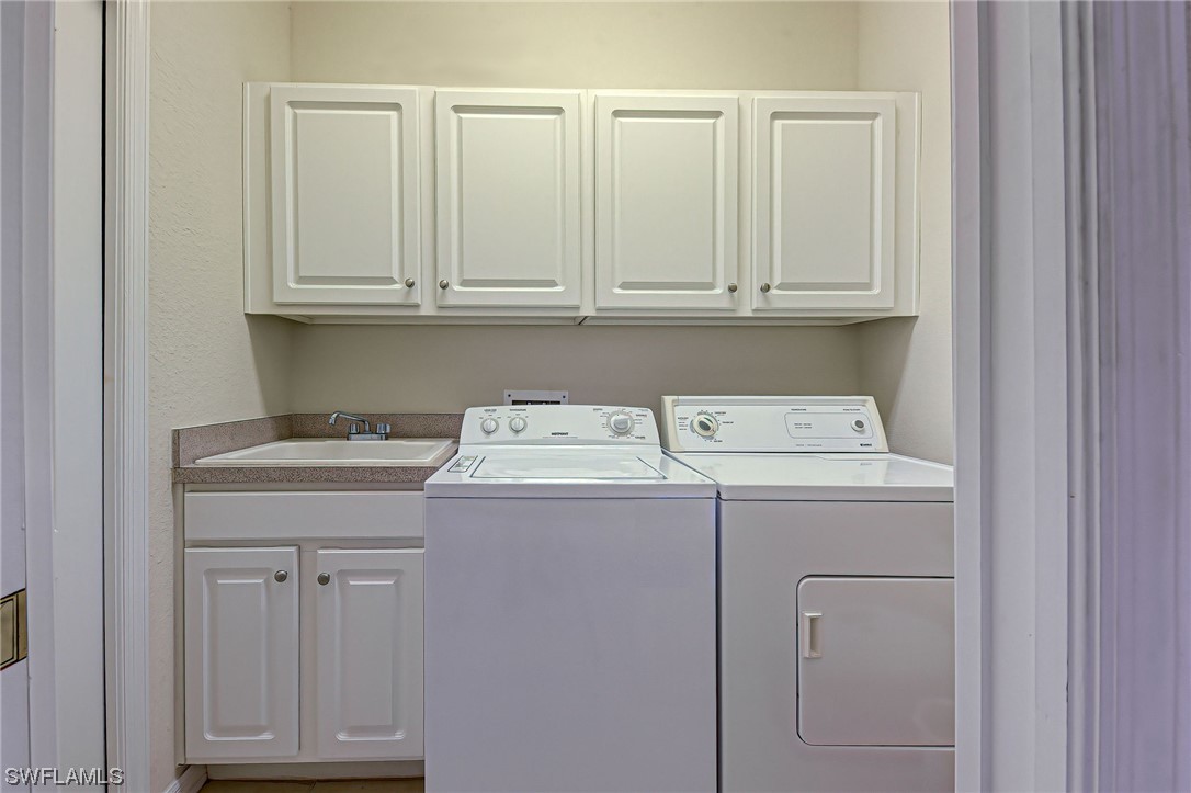 604 Ravinia Circle, Unit 604 Venice, FL 34292 - Photo 36 of 37 a utility room with dryer and washer