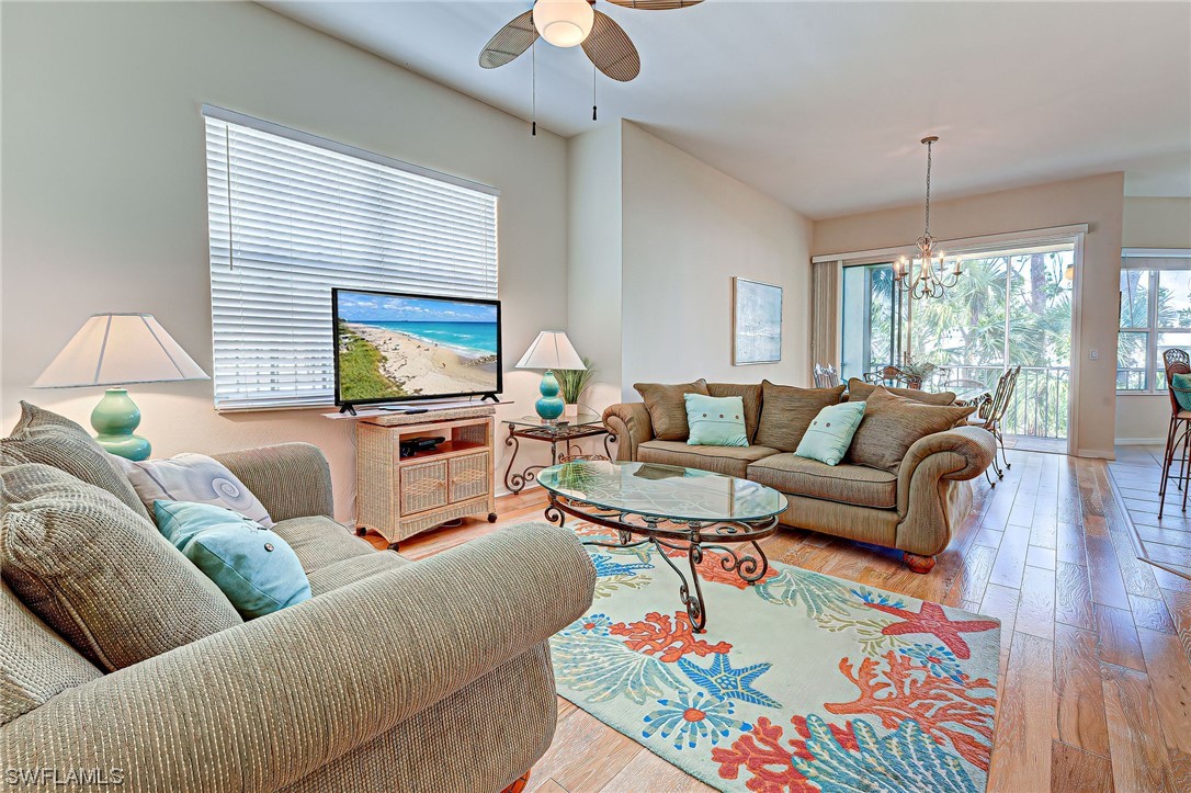 604 Ravinia Circle, Unit 604 Venice, FL 34292 - Photo 8 of 37 a living room with furniture and a flat screen tv
