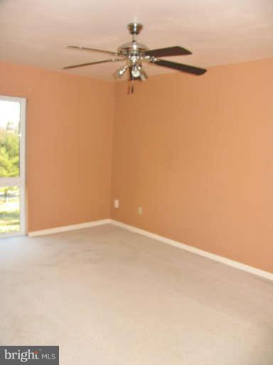 6137 Edsall Road, Unit J Alexandria, VA 22304 - Photo 9 of 13 a view of a room with a window and a ceiling fan