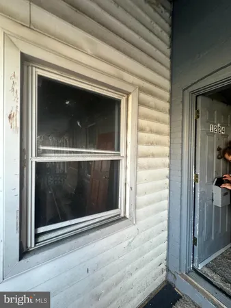a view of a hallway with wooden floor and a fireplace