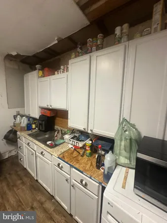 a kitchen with sink a stove and cabinets