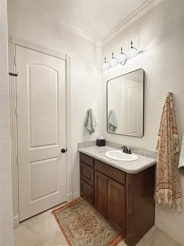 a bathroom with a sink vanity and mirror