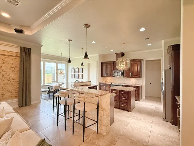 a large kitchen with a table and chairs