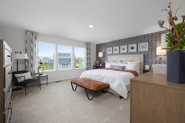 a spacious bedroom with a bed and large windows