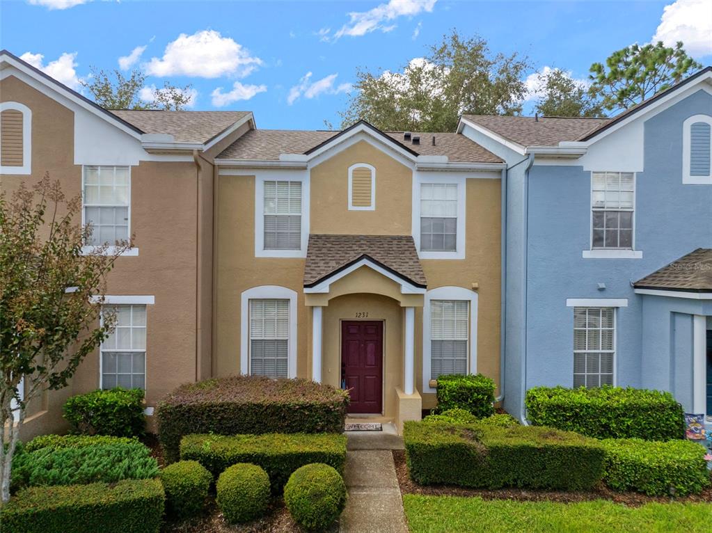 1231 Charlesworth Drive Wesley Chapel, FL 33543 - Photo 1 of 41 a front view of a house with garden