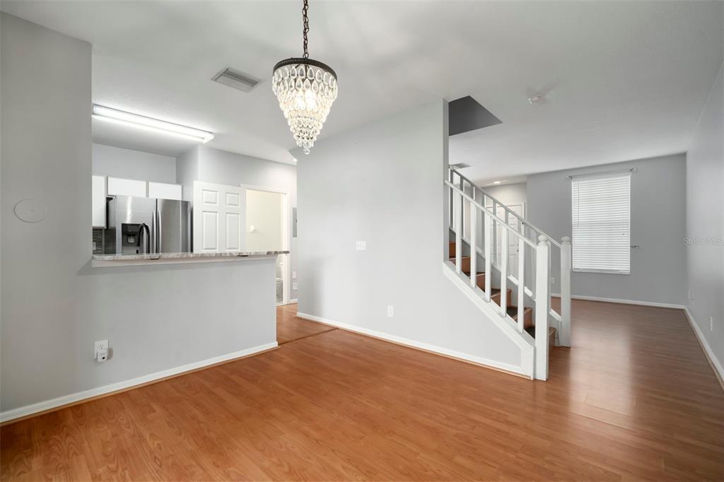 1231 Charlesworth Drive Wesley Chapel, FL 33543 - Photo 19 of 41 a view of an empty room with wooden floor