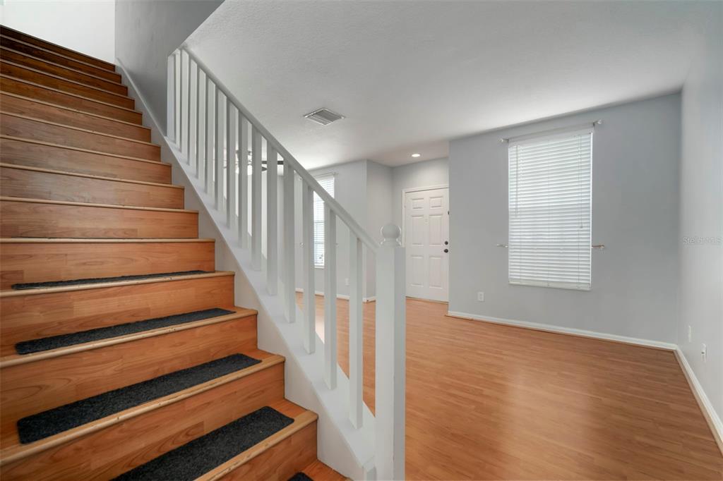 1231 Charlesworth Drive Wesley Chapel, FL 33543 - Photo 20 of 41 a view of entryway and hall with wooden floor