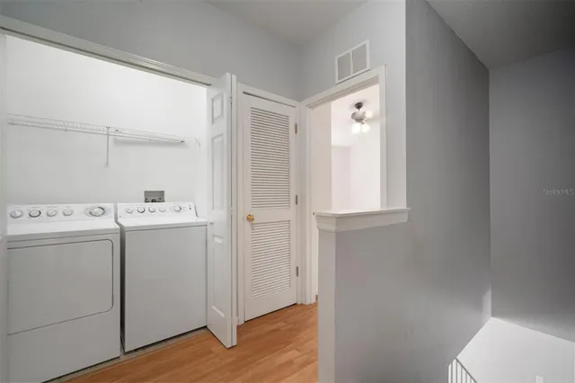 a view of an empty room with a window and a ceiling fan