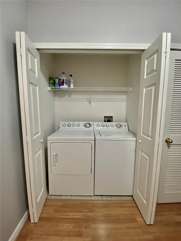1231 Charlesworth Drive Wesley Chapel, FL 33543 - Photo 23 of 41 a utility room with cabinets washer and dryer