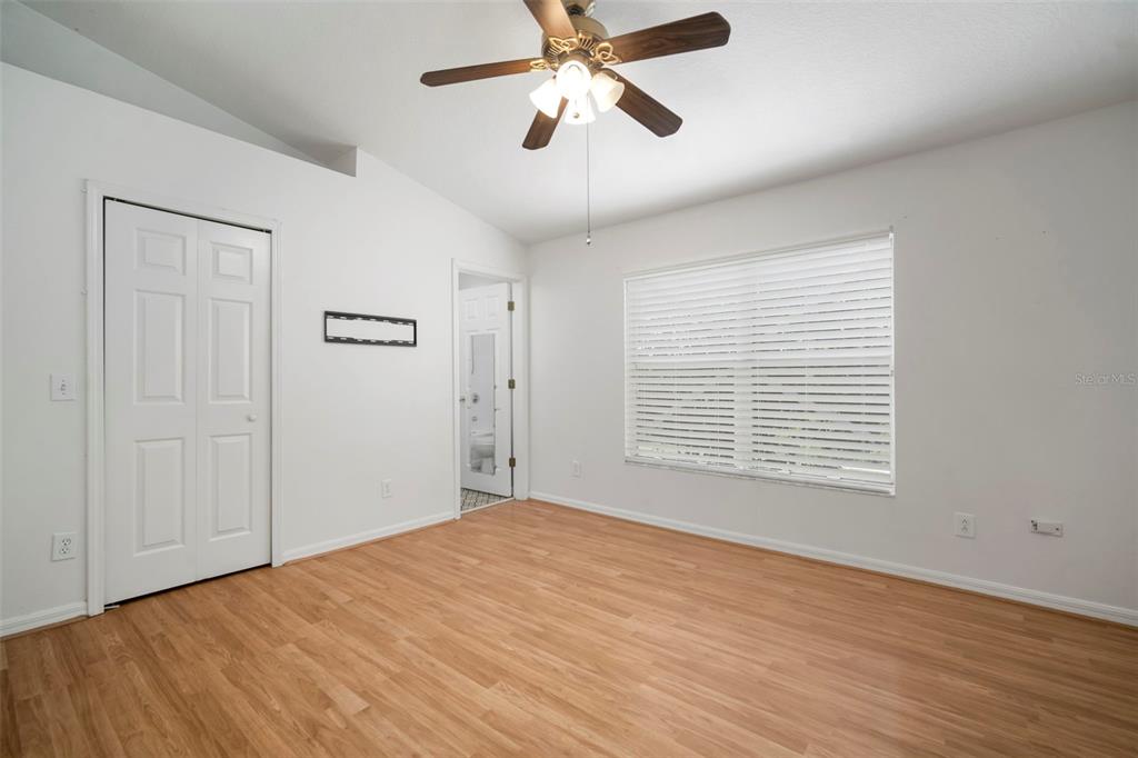 1231 Charlesworth Drive Wesley Chapel, FL 33543 - Photo 25 of 41 a view of an empty room with a window and a ceiling fan
