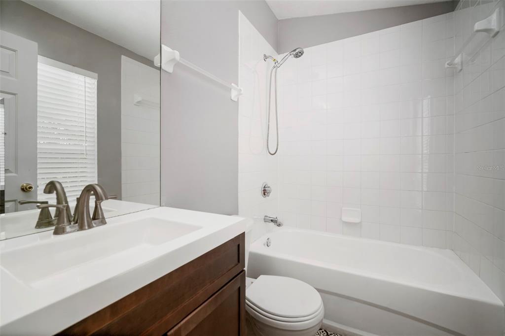 1231 Charlesworth Drive Wesley Chapel, FL 33543 - Photo 28 of 41 a bathroom with a bathtub shower sink vanity mirror and toilet