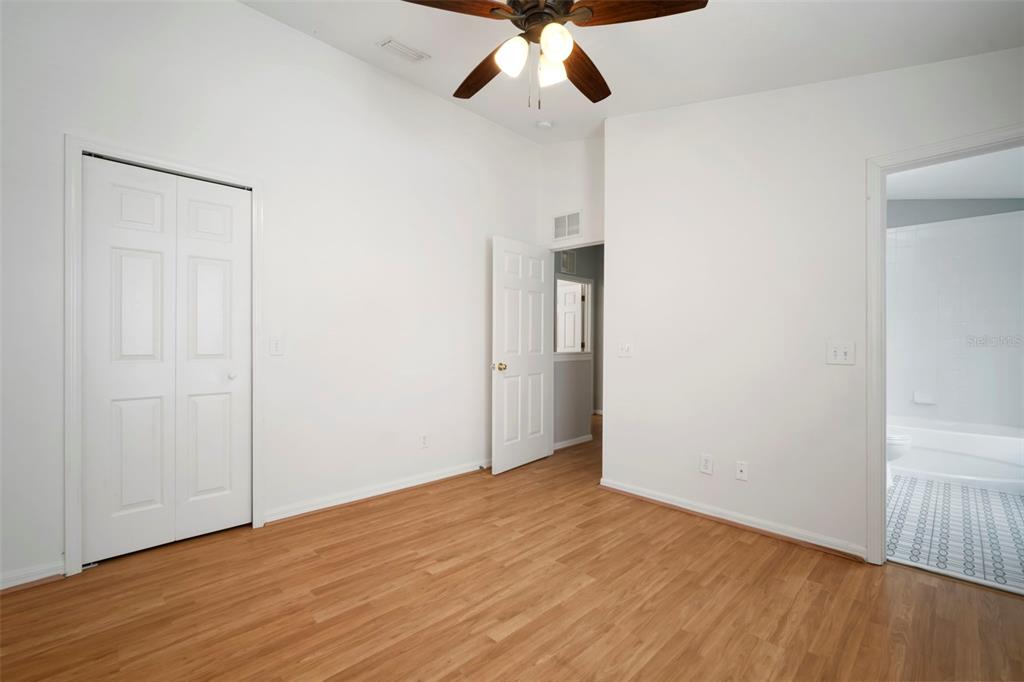 1231 Charlesworth Drive Wesley Chapel, FL 33543 - Photo 31 of 41 a view of empty room with wooden floor and ceiling fan