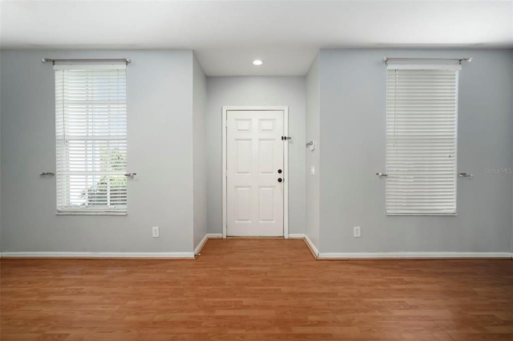 1231 Charlesworth Drive Wesley Chapel, FL 33543 - Photo 5 of 41 a view of an empty room with wooden floor and a window