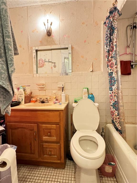 451 73rd Street Brooklyn, NY 11209 - Photo 14 of 16 a bathroom with a toilet a sink and mirror
