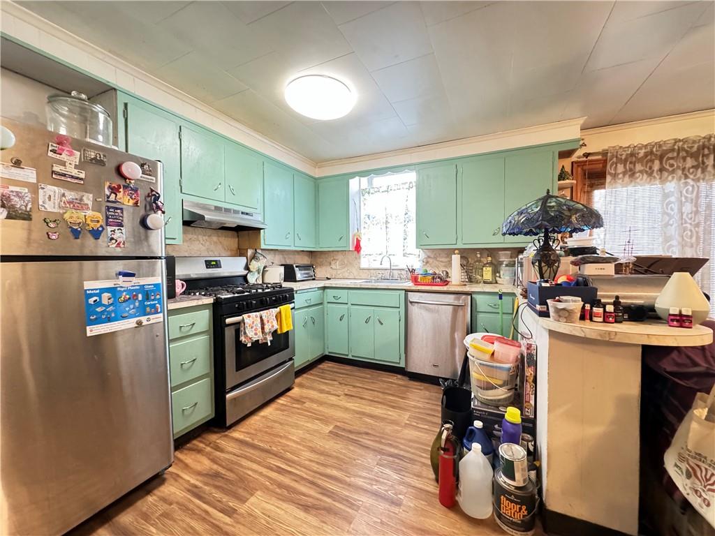 451 73rd Street Brooklyn, NY 11209 - Photo 10 of 16 a kitchen with a refrigerator and a stove top oven