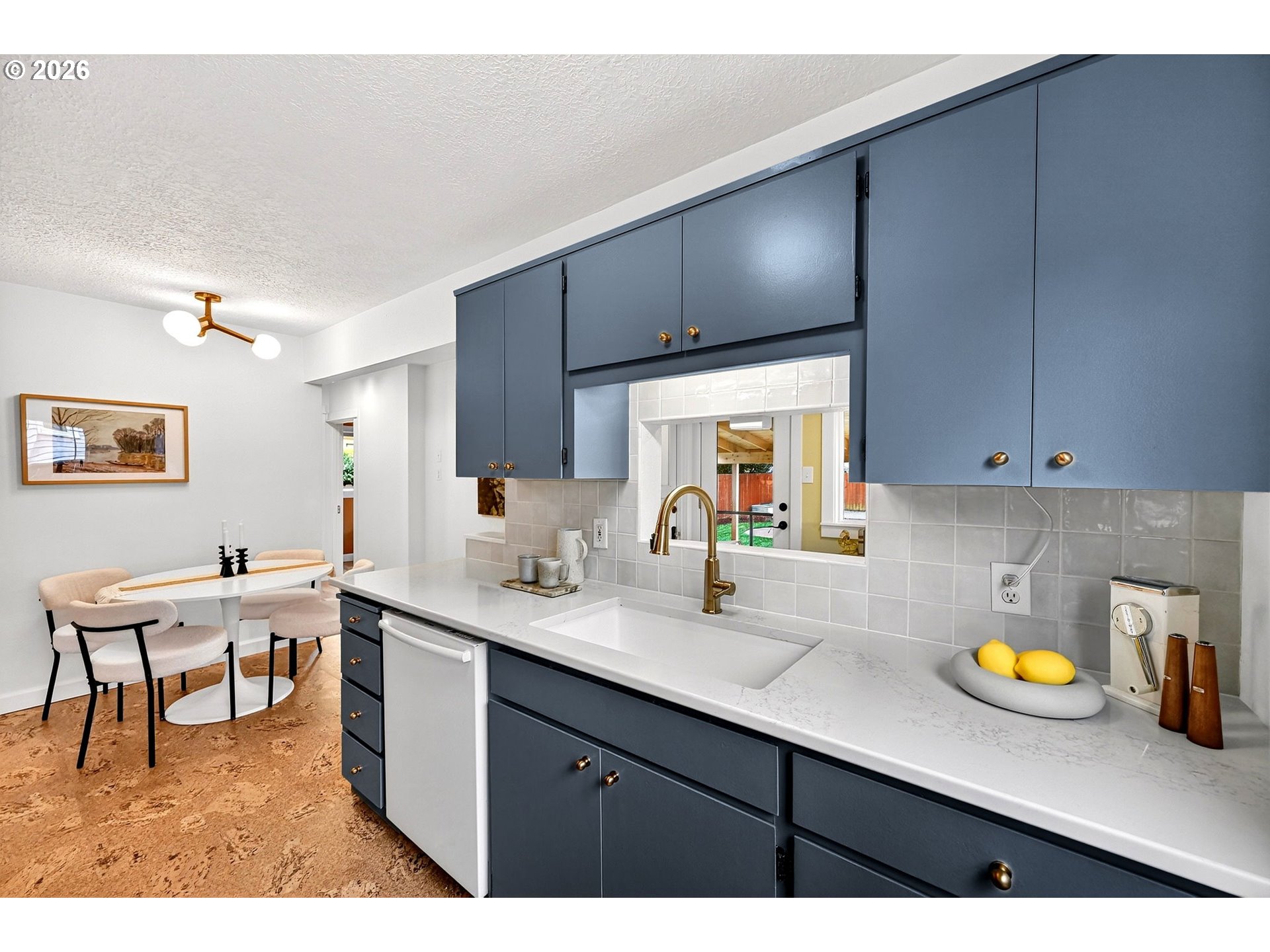 6128 Southeast Reedway Street Portland, OR 97206 - Photo 14 of 40 a kitchen with a sink cabinets and wooden floor