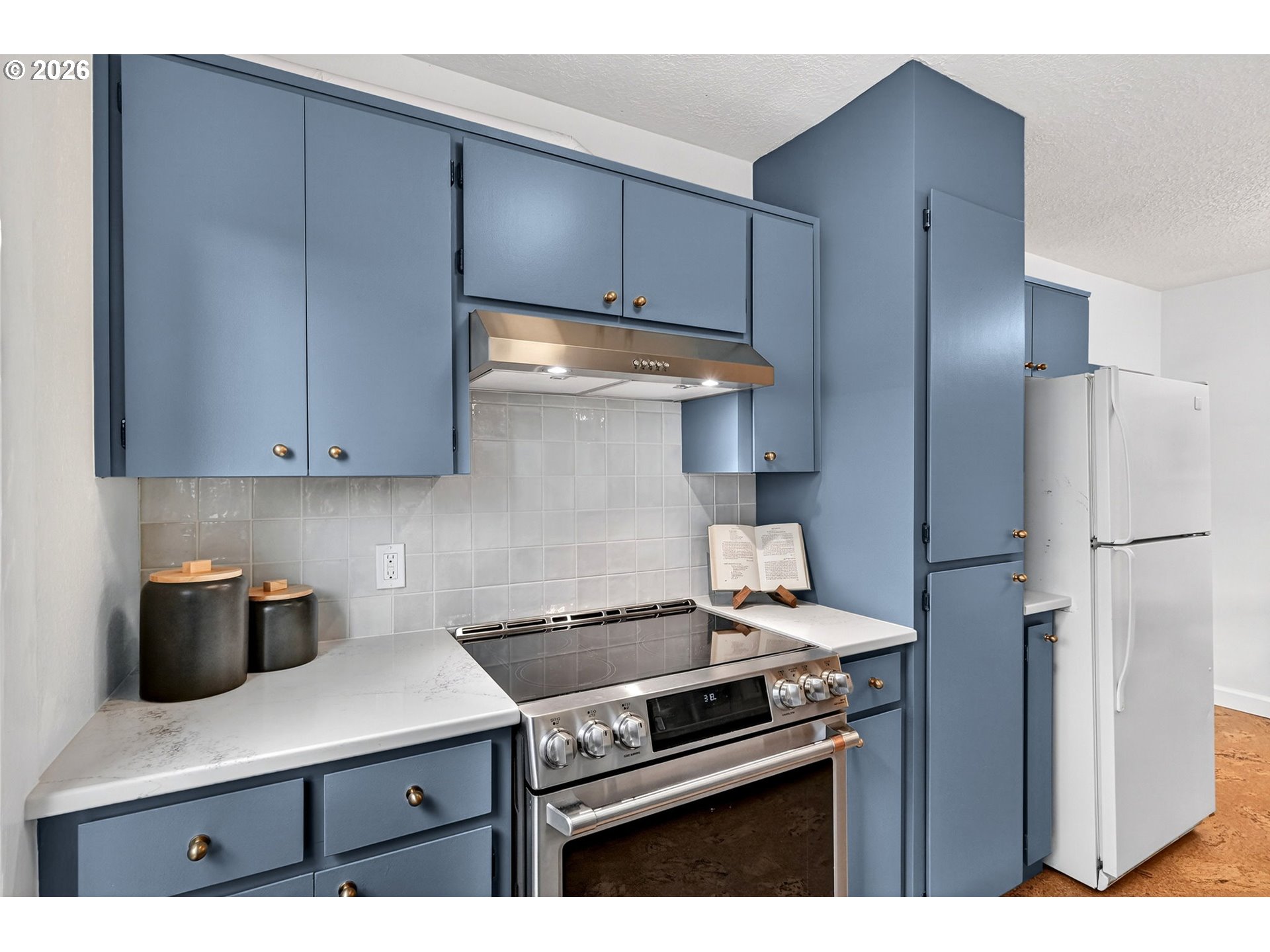 6128 Southeast Reedway Street Portland, OR 97206 - Photo 15 of 40 a kitchen with a stove and a refrigerator