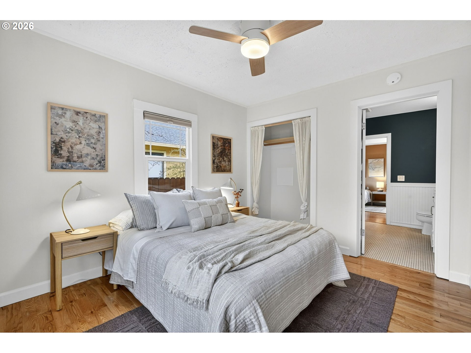 6128 Southeast Reedway Street Portland, OR 97206 - Photo 18 of 40 a bedroom with a bed and a chair