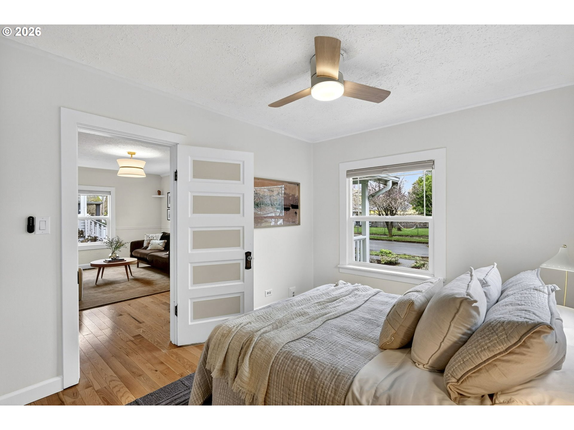 6128 Southeast Reedway Street Portland, OR 97206 - Photo 19 of 40 a bedroom with a bed and a chandelier