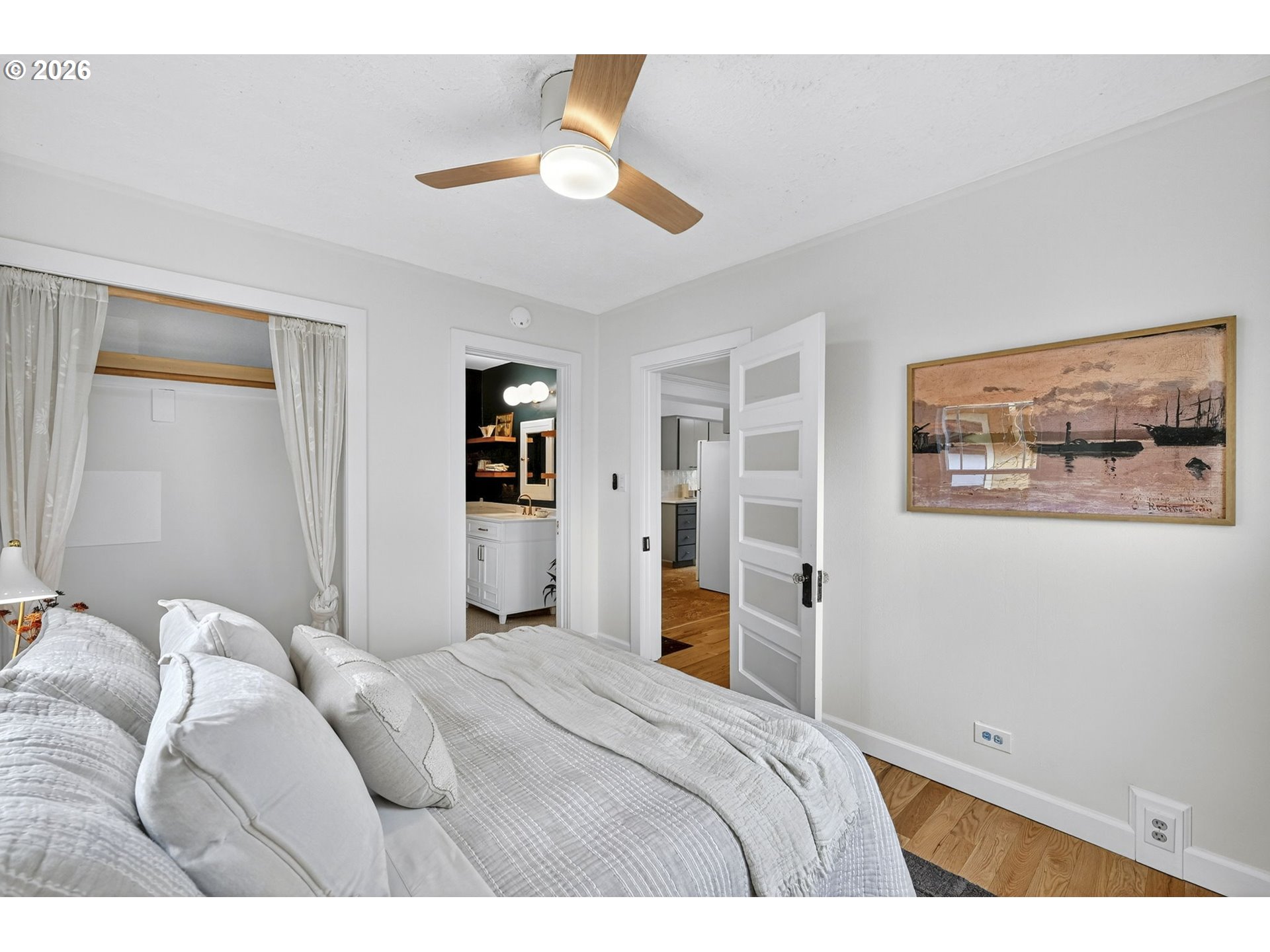 6128 Southeast Reedway Street Portland, OR 97206 - Photo 20 of 40 a bedroom with a large bed and a chandelier