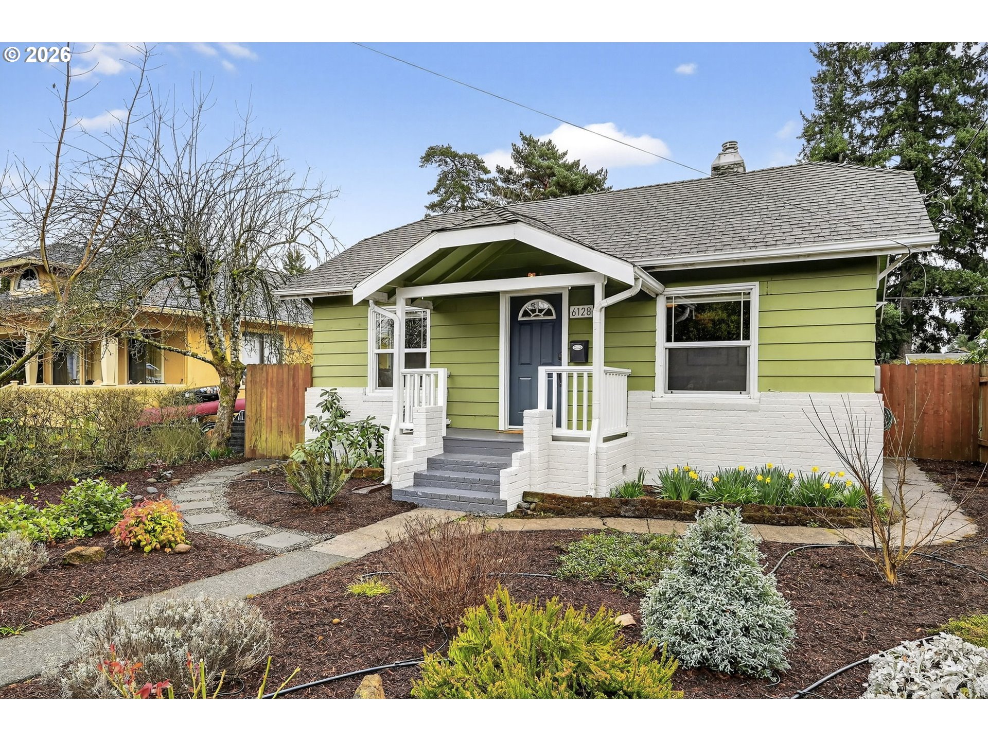 6128 Southeast Reedway Street Portland, OR 97206 - Photo 2 of 40 a front view of a house with a porch