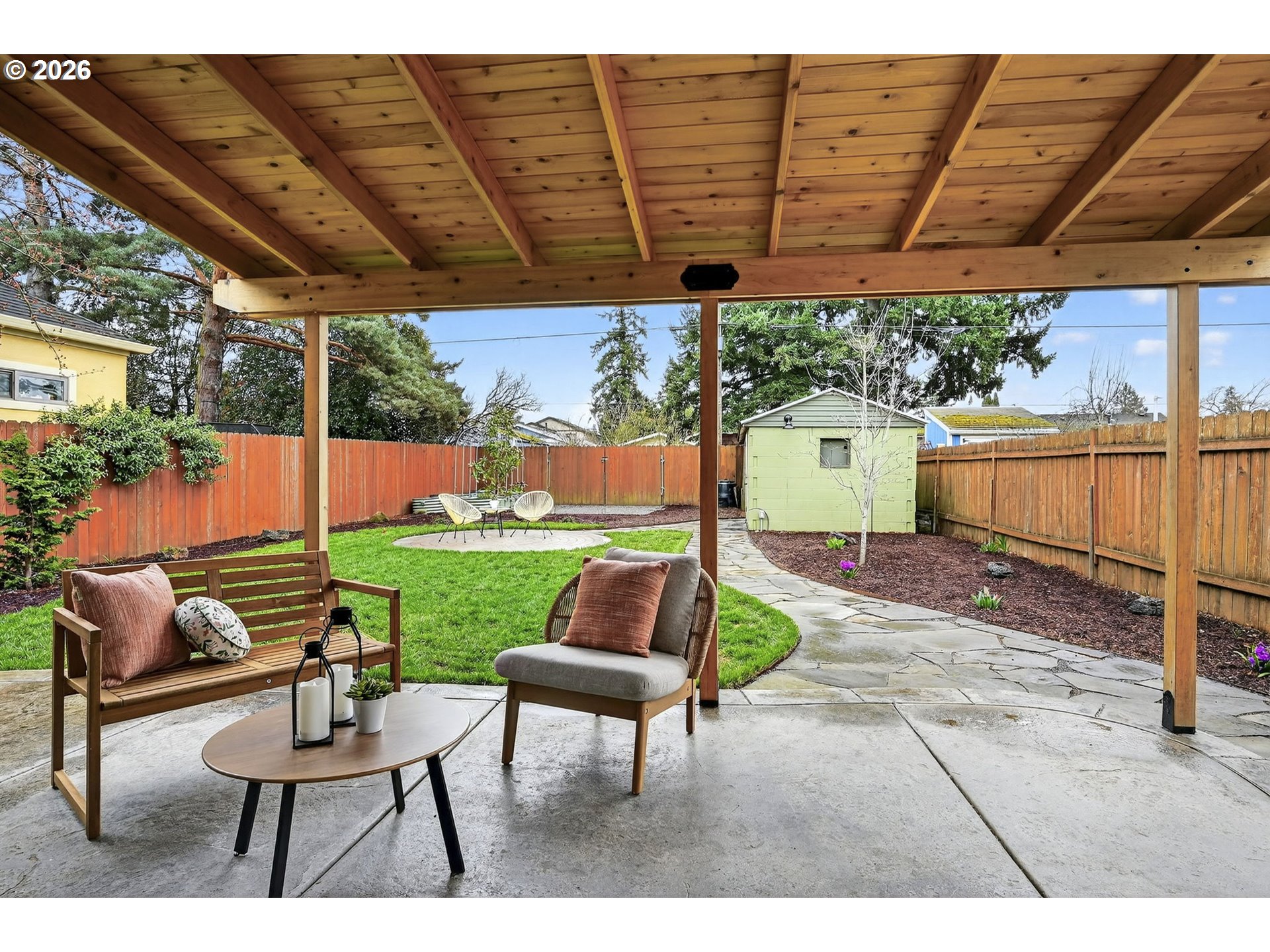 6128 Southeast Reedway Street Portland, OR 97206 - Photo 29 of 40 a backyard of a house with a garden and outdoor seating