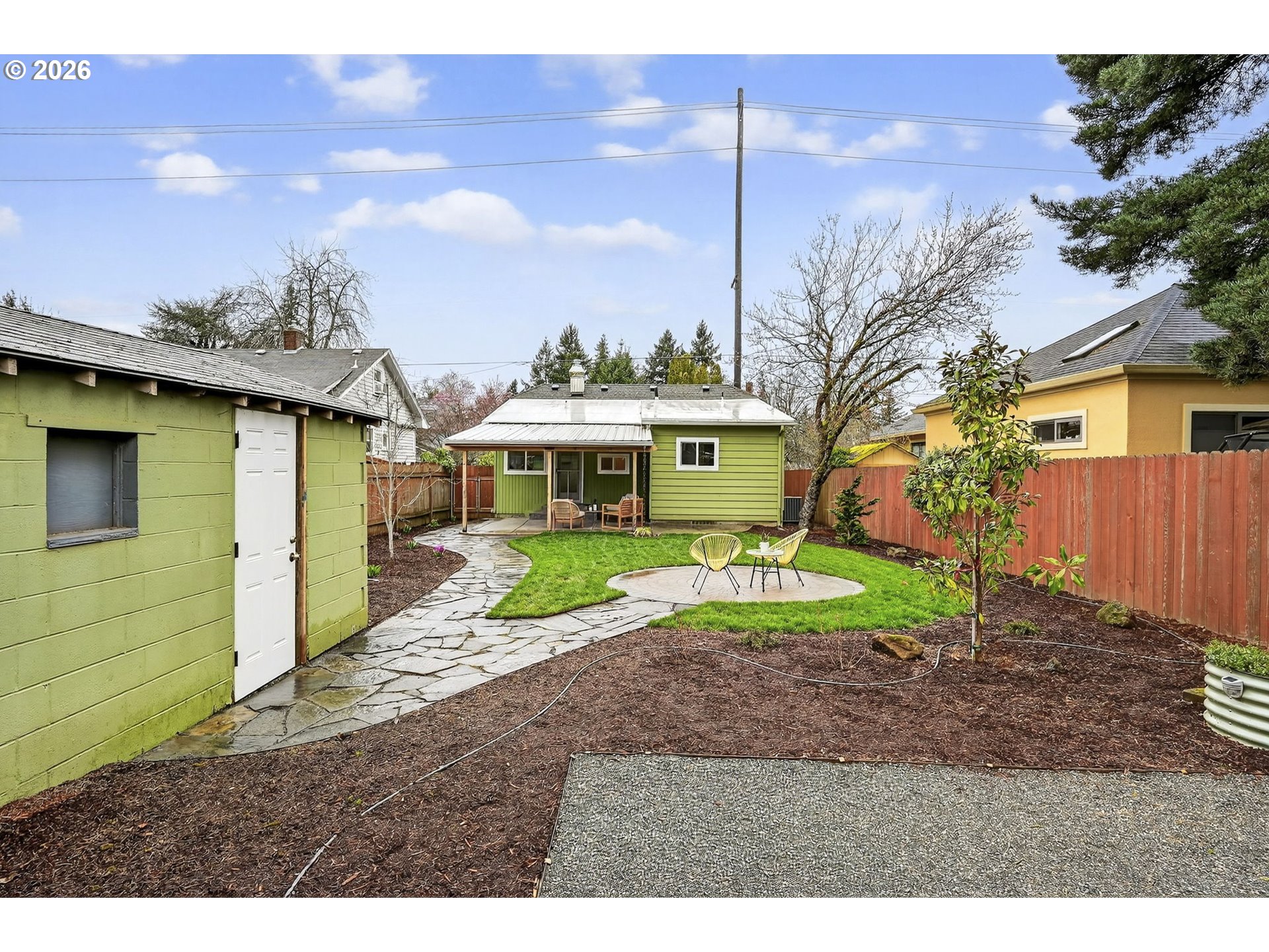 6128 Southeast Reedway Street Portland, OR 97206 - Photo 35 of 40 a front view of a house with a yard and garage
