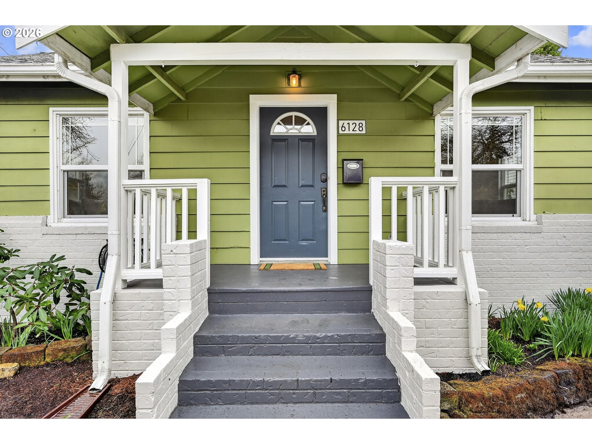 6128 Southeast Reedway Street Portland, OR 97206 - Photo 5 of 40 a front view of a house with a garden