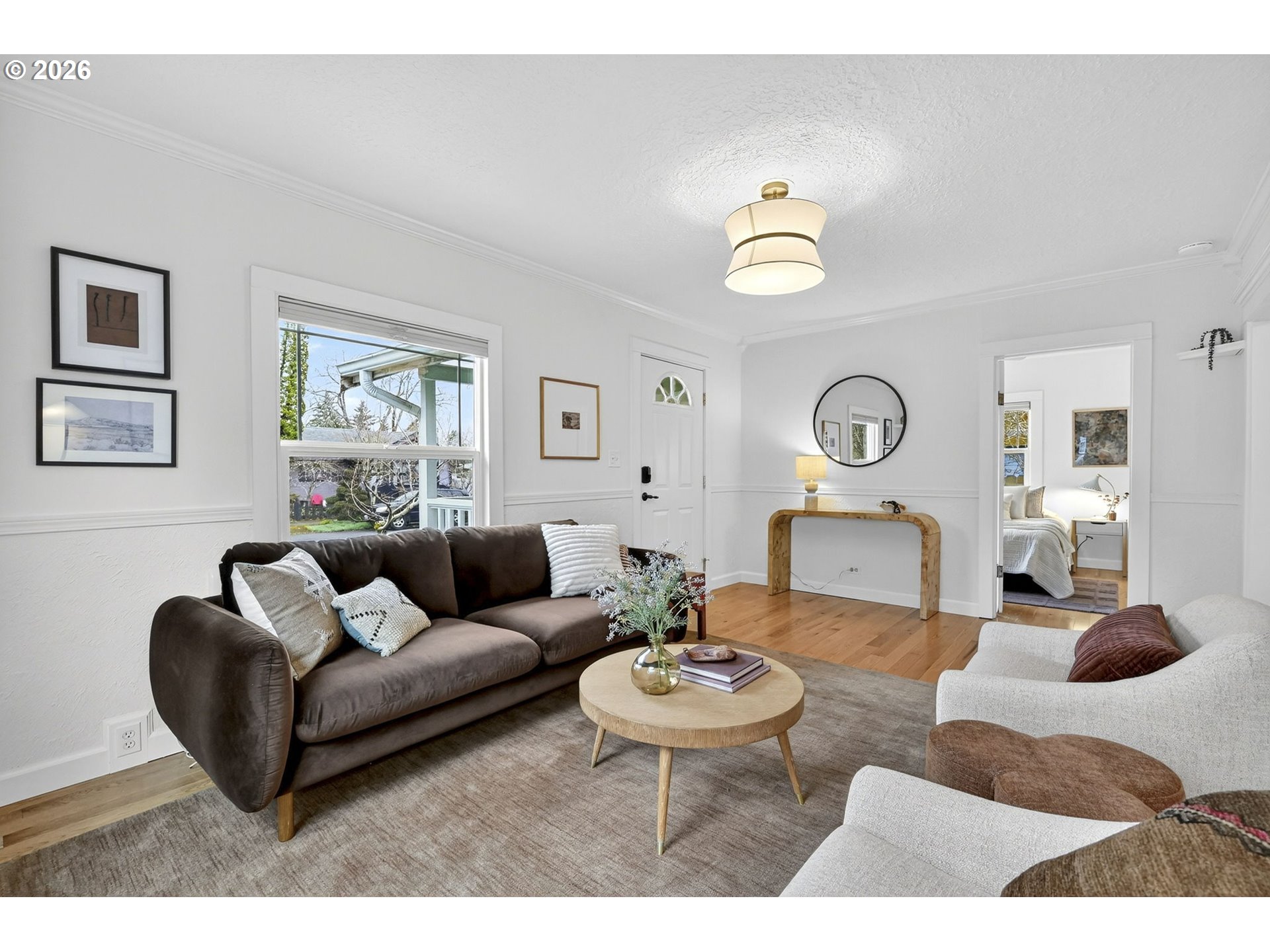 6128 Southeast Reedway Street Portland, OR 97206 - Photo 9 of 40 a living room with furniture a rug and wall paintings