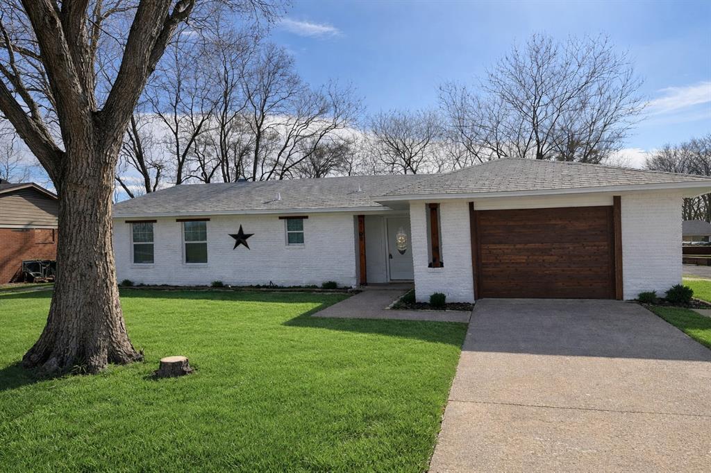2105 Proctor Street Grand Prairie, TX 75051 - Photo 1 of 1 a front view of a house with a garden and yard