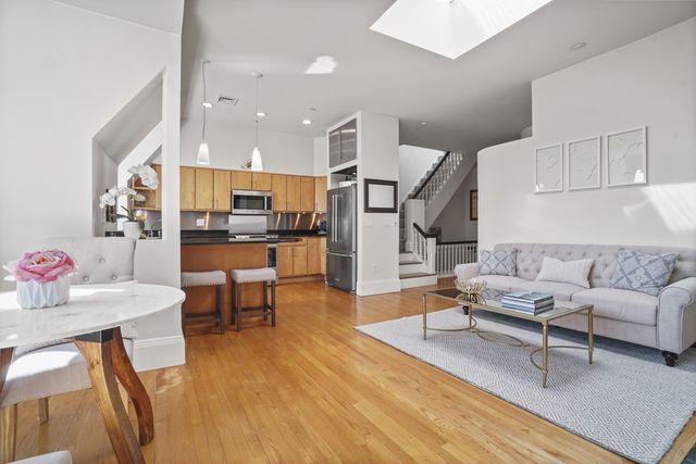 a living room with furniture and kitchen view