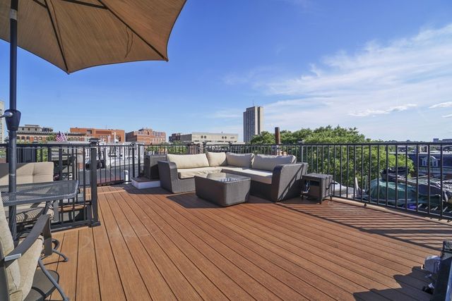 a terrace with outdoor seating and city view