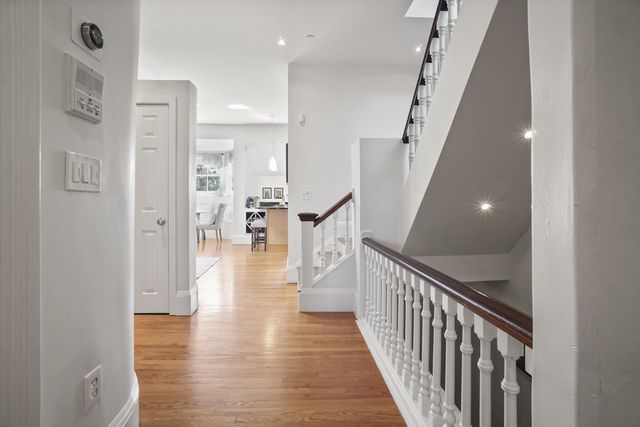 a view of a hallway view with wooden floor and staircase