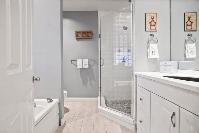 a bathroom with a granite countertop sink a shower and a mirror