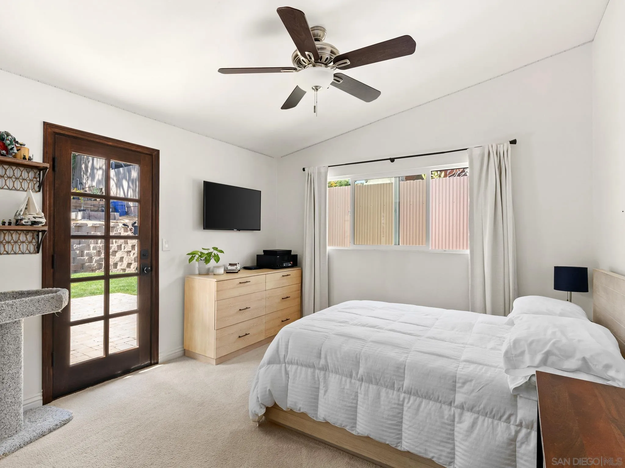 331 Glencrest Drive Solana Beach, CA 92075 - Photo 19 of 43 a bedroom with a balcony a bed and a flat screen tv