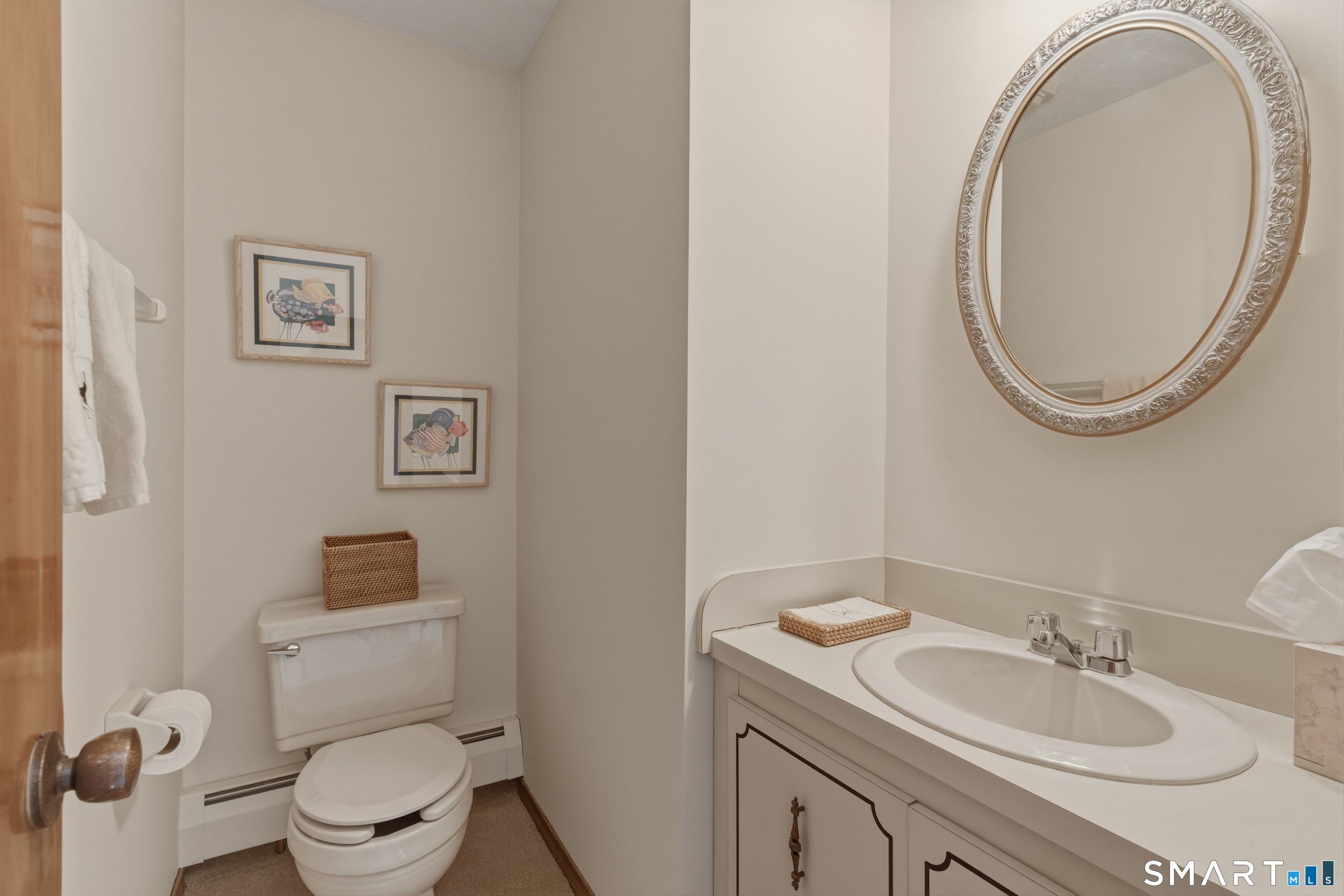 15 Potter Crossing, Unit 15 Wethersfield, CT 06109 - Photo 12 of 21 a bathroom with a toilet a sink and a mirror